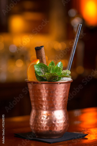 Fotografia, Obraz Cocktail. Mint Julep with orange in copper glass and steel straw