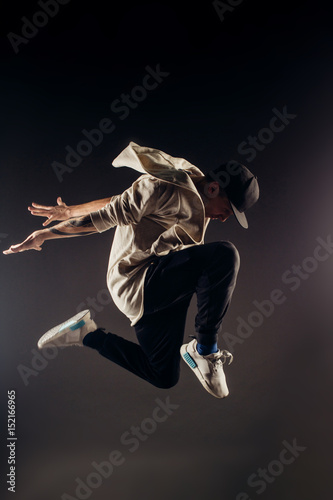 Cuadros en Lienzo Jumping young male dancer on grey background
