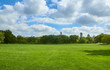 Empty large green lawn in Central Park with skyscrapers in the background