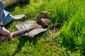 Farming, gardening, agriculture and people concept -man with shovel digging garden bed or farm