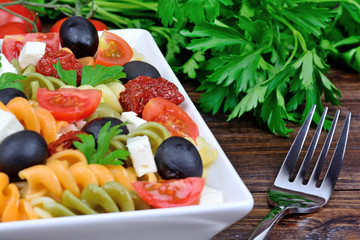 Poster - Colorful pasta with vegetable and fork on table