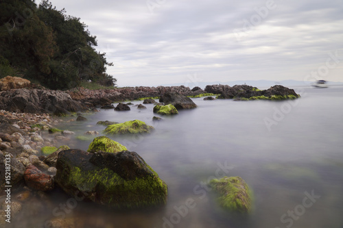 Photographie Long Exposured Rocky Beach with Green Seaweeds On The Rocks