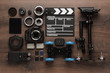 different video making equipment for indie production on brown wooden table view from above. short movie production essentials