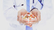 © lenets_tan - Doctor holding heap of drugs in a hand