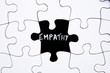 Puzzle Pieces - with word Empathy in black chalkboard space
