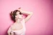 © bublik_polina - close-up portrait of young beautiful slim sexy young blonde woman in a retro pin-up style on pink background in studio wearing sunglasses smiling and posing