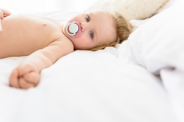 Pretty little infant sucking dummy