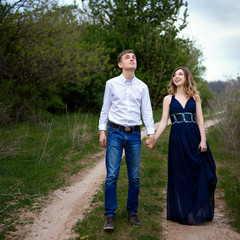 Couple in love walking in the woods holding hands 