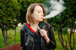 Portrait of a beautiful young girl with vape. Vaping concept