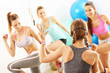 © Kalim - Group of smiling people doing aerobics