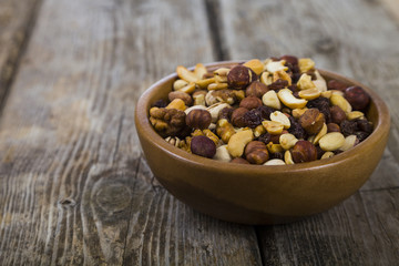 Nuts in a wooden bowl  on a  wooden table.