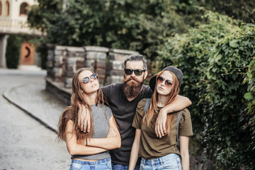 Poster - man hugging two pretty girls