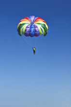 Skydiver On Colorful Parachute In Sunny Blue Sky. Active Lifestyle. Extreme Sport.