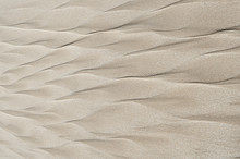 Geometric Patterns On Beach Sand In The Form Of A Feather