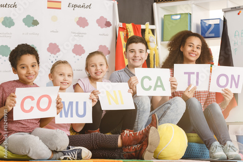 Woman and kids holding communication inscription Canvas Print