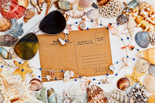 Mediterranean Styled Still Life With Vintage Postcard, Sunglasses And Sea Shells