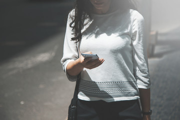 Wall Mural - woman hand phone in street