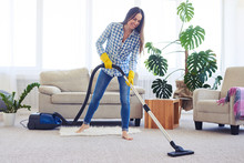 Slim Woman Cleaning With Vacuum Cleaner Carpet