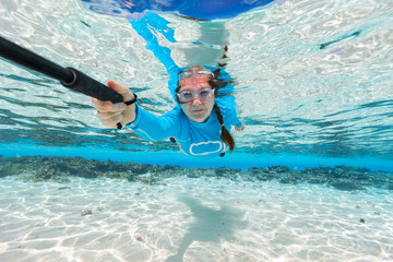 Wall Mural - Woman swimming underwater