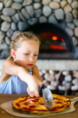 Canvas Print - Little girl eating pizza