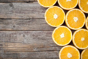 Sticker - Close up shot of half cut oranges on an old wooden background