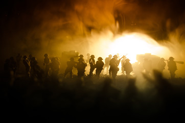 Wall Mural - War Concept. Military silhouettes fighting scene on war fog sky background, World War Soldiers Silhouettes Below Cloudy Skyline At night. Attack scene. Armored vehicles