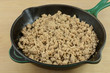 Cooked ground turkey meat in cast iron frying pan