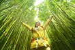 © Maridav - Bamboo forest nature woman environment freedom with open arms in success. Environmental eco friendly sustainability concept. Hiker hiking on Pipiwai Trail on famous road to hana travel, Maui, Hawaii.