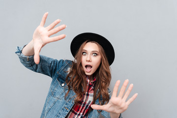 Poster - Close up portrait of a cheerful young woman in hat