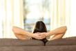 Woman relaxing looking through window on a couch