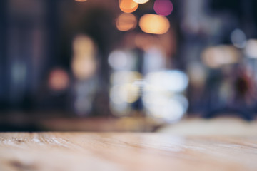 Wooden table in cafe with blur bokeh abstract vintage background