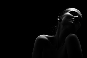 beautiful totpless woman with closed eyes on black background monochrome