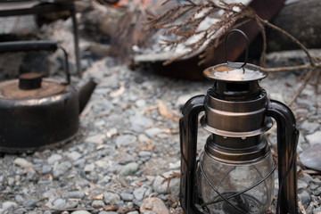 Camp landscape with lantern and a kettle