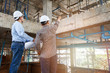 © skarie - Engineer and  foreman discussing in building construction site