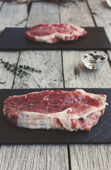 Sticker - Raw beef steak on dark wooden table background