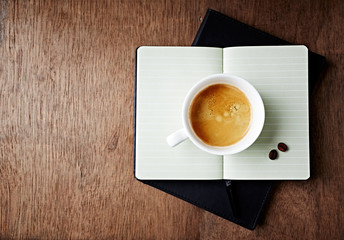 Wall Mural - Cup of Coffee on an open Notebook