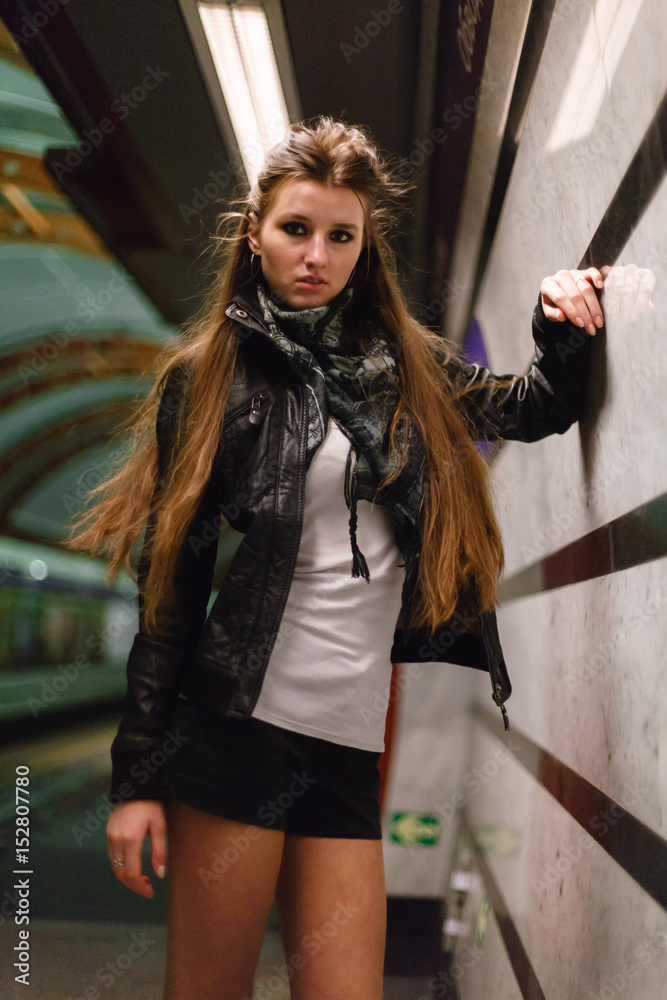 Fashionable young woman in black leather jacket on a background of ...