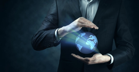 Wall Mural - businessman hand global planet in screen