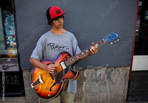 Pedro Gonzalez poses with a guitar outside a guitar store in ...