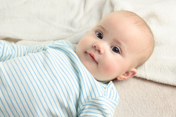 Sticker - Portrait of adorable baby on light towel