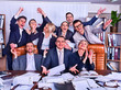 © Gennadiy Poznyakov - Business people office life of team people are happy with hand up sitting table . Cabinets with folders in background. People in suits glad with successful deal and celebrate success in office.