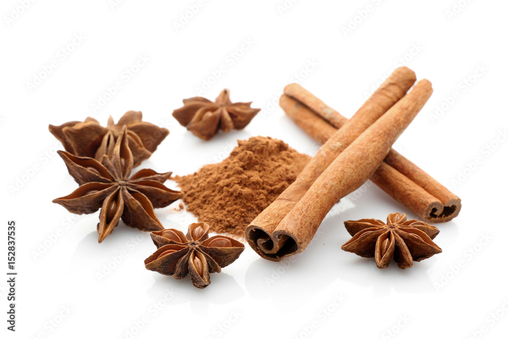 Cinnamon sticks and powder with anise stars isolated on white