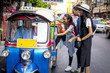 Three asian girls are taking Tuktuk to travel around Chinatown, Thailand