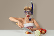 © ipolstock - Young woman cutting onion in diving mask