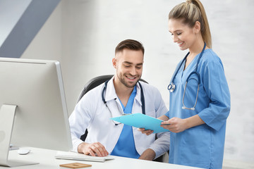 Poster - Doctor and medical assistant discussing issue in office