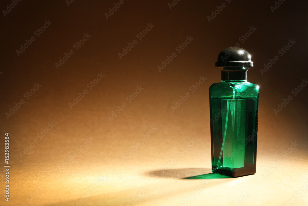 Bottle of modern male perfume on color background