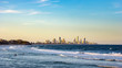 Surfers Paradise waterfront skyline with famous Q1 skyscraper from beach at Sunset. Modern cityscape beach landscape wave in Summer. Surfers Paradise city in Gold Coast region of Queensland, Australia