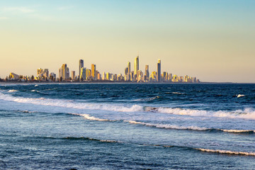 Wall Mural - Surfers Paradise waterfront skyline with famous Q1 skyscraper from beach at Sunset. Modern cityscape beach landscape wave in Summer. Surfers Paradise city in Gold Coast region of Queensland, Australia