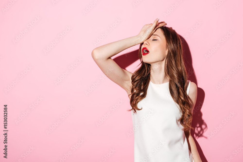 Portrait of annoyed beautiful woman placing back hand on forehead - obrazy, fototapety, plakaty 