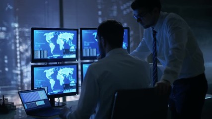 Leinwandbilder - Late at Night in Office Building Security Service Men Have Discussion while  Attentively Observing Monitors with Location Sensitive Information Shown on Them. Shot on RED EPIC-W 8K Helium Camera